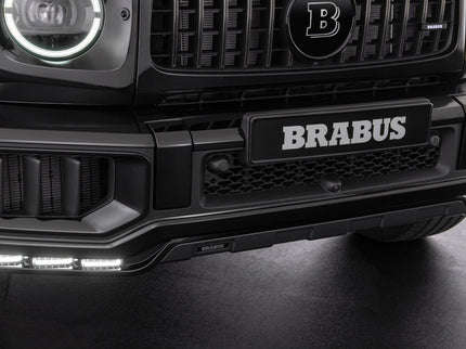 Close-up of a Brabus car front bumper with logo on a dark background
