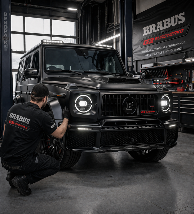Black BRABUS vehicle in a garage with a person working on it, featuring BRABUS branding.