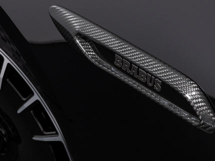 Carbon fiber car spoiler with Brabus branding on a dark background