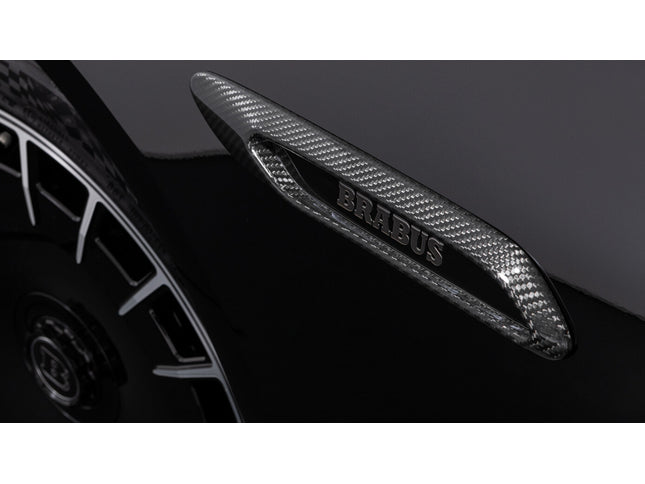 Carbon fiber car spoiler with Brabus branding on a dark background