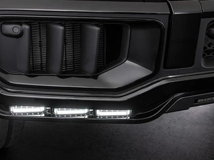 Close-up of a vehicle's front grille with LED lights on a dark background