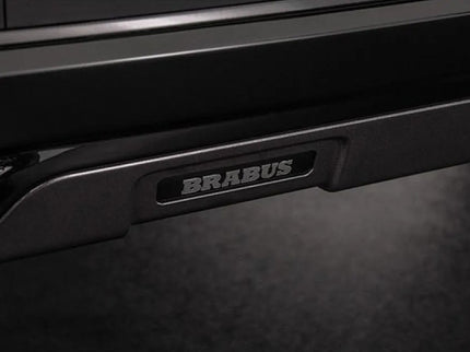 Close-up of a Brabus logo on a vehicle's side panel.