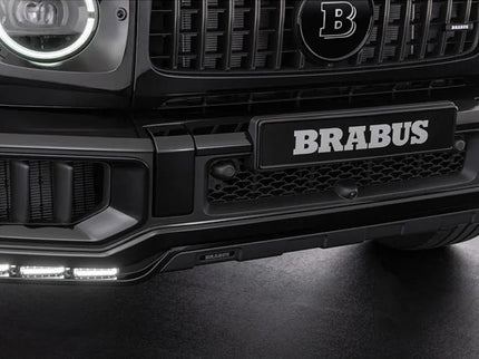 Close-up of a Brabus car front bumper with logo on a dark background