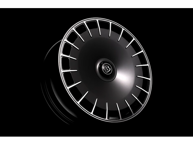 Car wheel rim with a brand logo on a black background