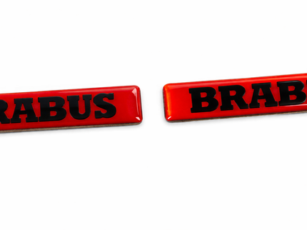 Two red 'BRABUS' emblems on a white background