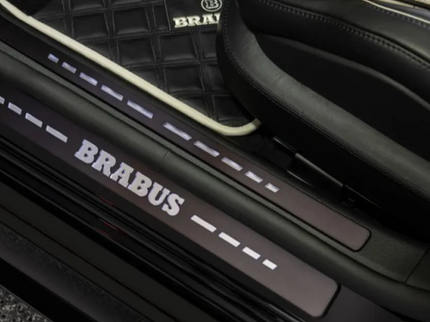 Car door sill with Brabus branding on a vehicle interior.
