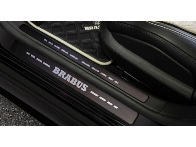 Car door sill with Brabus branding on a vehicle interior.