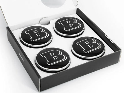 Four black coasters with a letter 'B' in a box on a white background