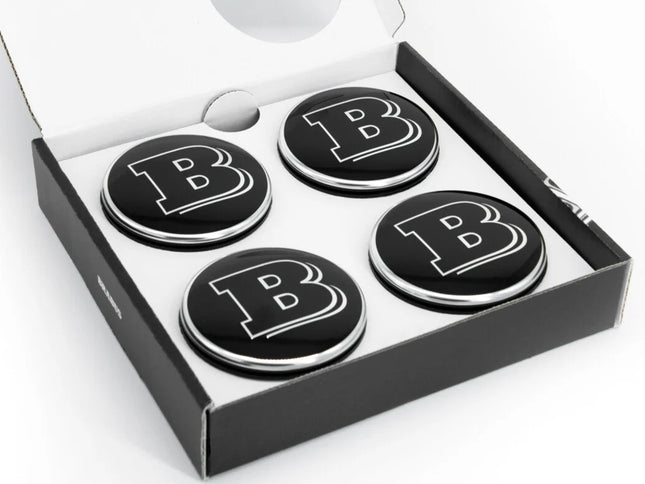Four black coasters with a letter 'B' in a box on a white background