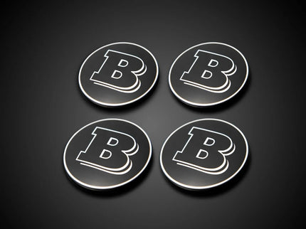 Four circular coasters with a letter 'B' on a black background