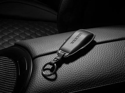 Car keychain with a brand logo on a car seat