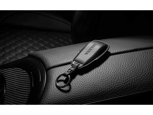 Car keychain with a brand logo on a car seat