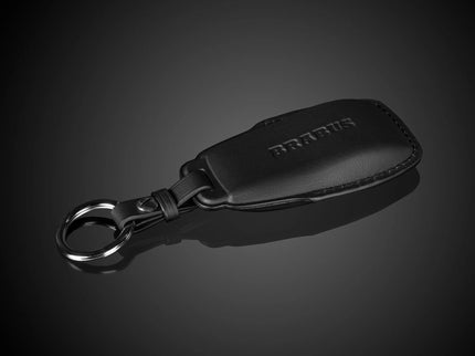 Black leather keychain with a metal ring on a dark background