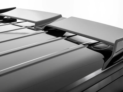 Car roof spoiler with 'R' branding on a gray car