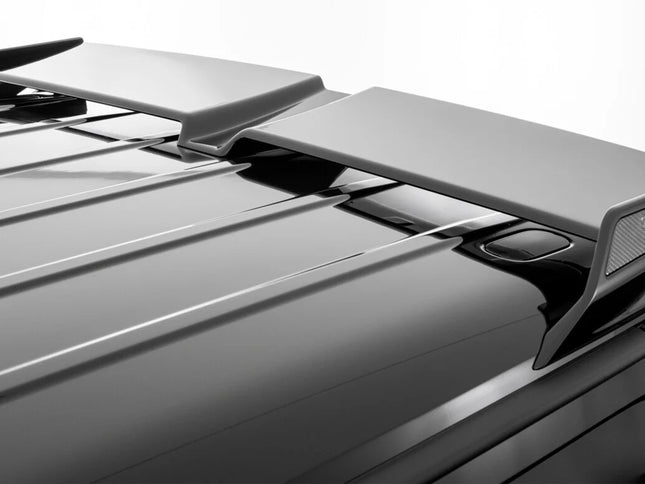 Car roof spoiler with 'R' branding on a gray car