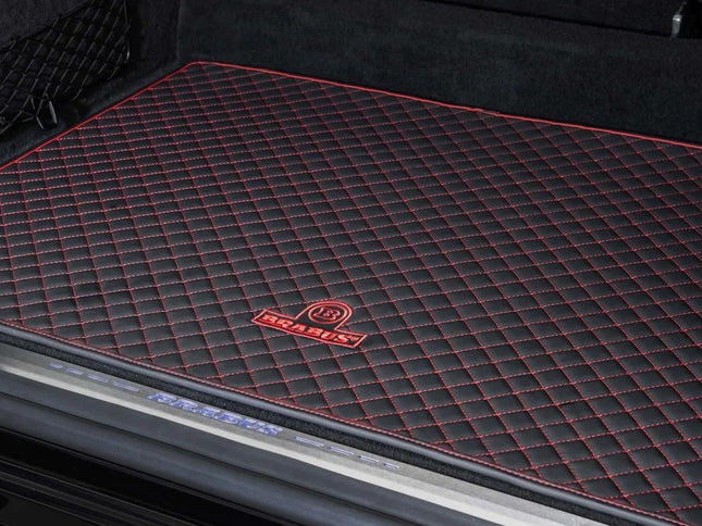 Black truck bed liner with red stitching and a logo on a black truck bed.