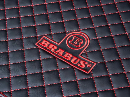 Brabus logo on a black textured surface with red stitching