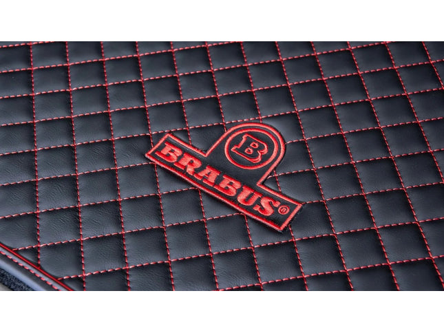 Brabus logo on a black textured surface with red stitching